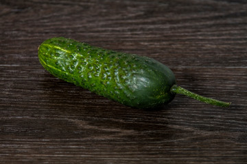ripe cucumber lies on the table