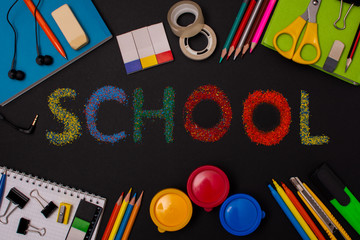 school supplies on the background of the blackboard. back to school. template with stationery