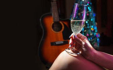 female hand holding champagne glass