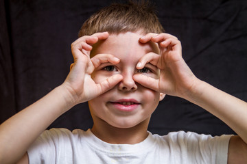Boy showing glasses with your hands