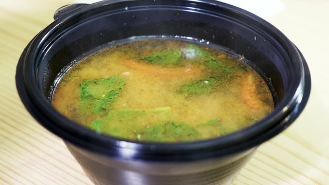 Close-up shot of traditional Tom Yam noodle soup in restaurant. 4K