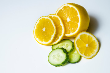 Fototapeta na wymiar ripe cucumber and lemon on white background