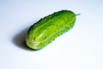 ripe cucumber on white background