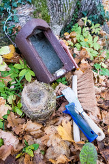 Fototapeta premium Nesting box, nest (blue tit) and tools for nesting box cleaning on forest floor