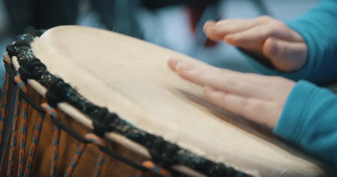 Close up of hands playing drum
