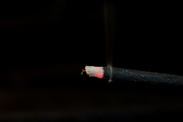 Macro of incense and smoke particles on black backgroud