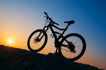 Silhouette of mountain bicycle at sunset