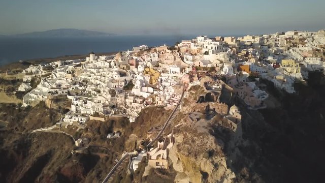 Wide aerial, sunset over town of Oia