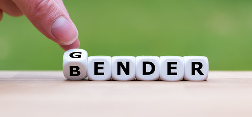 Hand is turning a dice and changes the word gender to bender