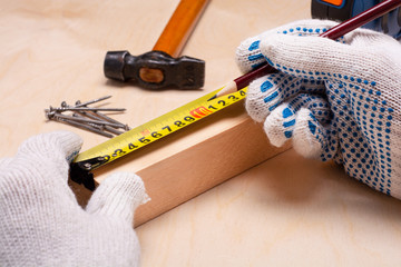 the man measures the distance on the board