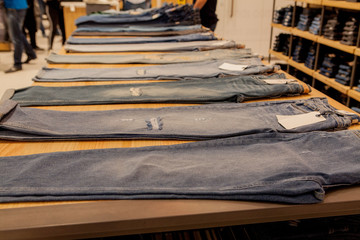 Jeans pants on the store shelf. Blue jeans denim Collection jeans stacked