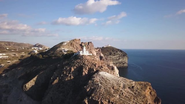Greece lighthouse on cliffs, wide aerial