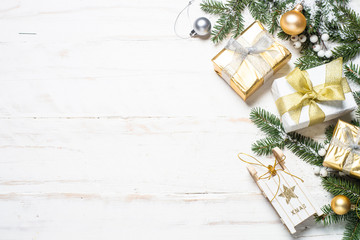 Christmas background with gold and silver decorations on white.