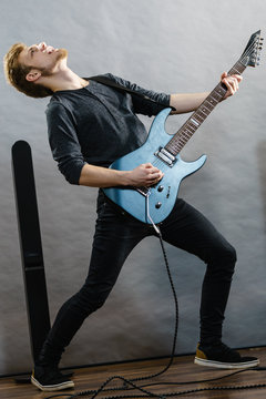 Young man playing electric guitar