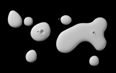 Spilled milk puddle isolated on black background and texture with clipping path, top view