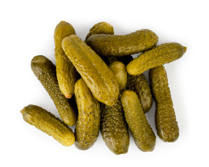 A bunch of pickles on a white. The view from the top.