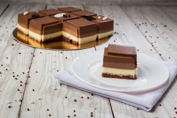 Dark chocolate vegan cake with candies on wooden background