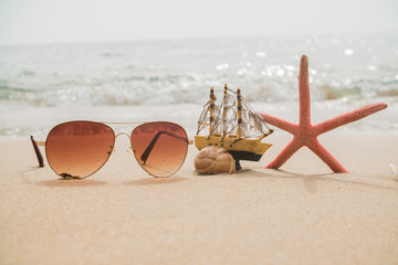background sunglasses starfish on the beach sand