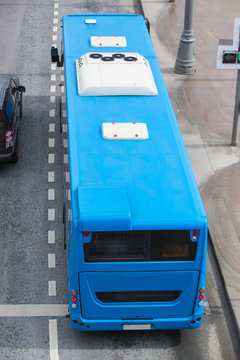 Blue city bus on moving road