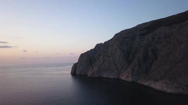 Sunset over Greek coastal cliffs, aerial