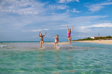 jump on the ocean beach against the blue sky and the sun