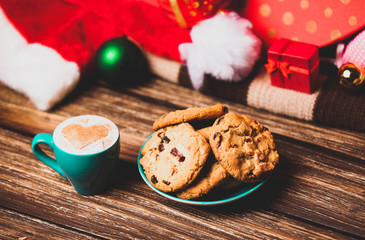 Cookie and cup of coffee on christmas background.