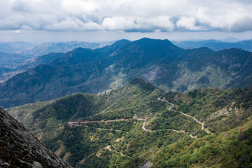 Fototapeta premium View of the valley in Sequoia National Park in California from the Moro Rock summit hiking trail. Winding twisty mountain road below