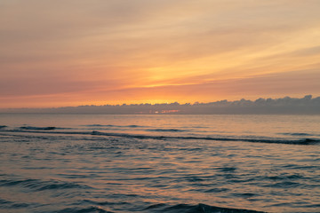 waves on the beach in the ocean at sunset