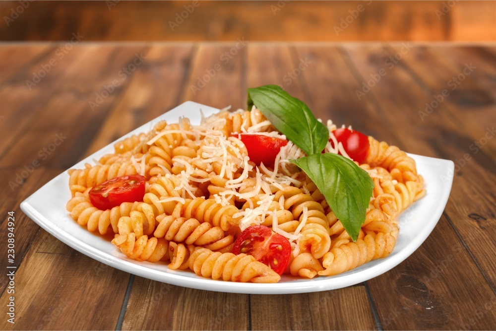 Wall mural a baked dish of fusilli or pasta spirals, with cherry tomatoes