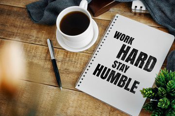 Inspirational and motivation life quote on notepad - Work Hard Stay Humble.