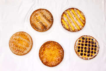 Five tasty  pie cakes on a white silk background