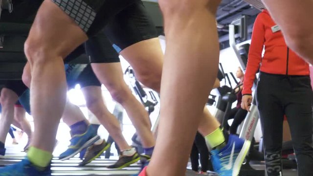 Close up foot sneakers Fitness people running on track treadmill. Feet of athletes running on track in gym