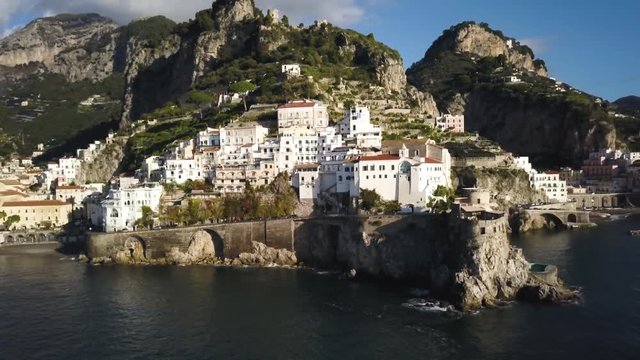 Panning aerial, coastal buildings in Amalfi