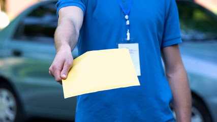 Courier giving document package, company delivery service, door to door shipping