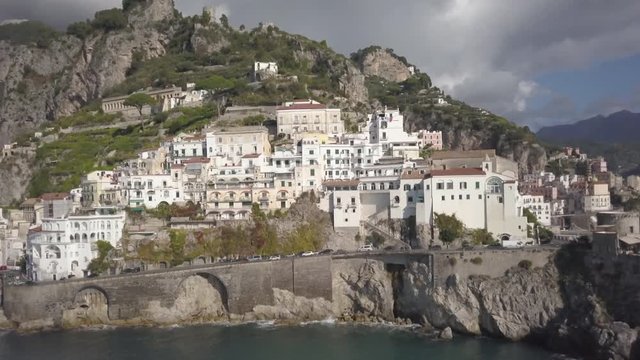 Cars drive under Amalfi architecture, aerial