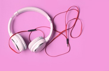 white music headphones isolated on purple background