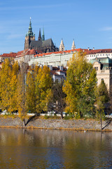 Colorful autumn Prague gothic Castle with the Lesser Town above River Vltava in the sunny Day, Czech Republic