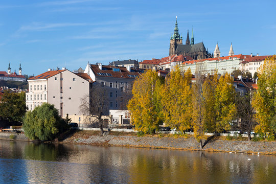 Colorful autumn Prague gothic Castle with the Lesser Town above River Vltava in the sunny Day, Czech Republic