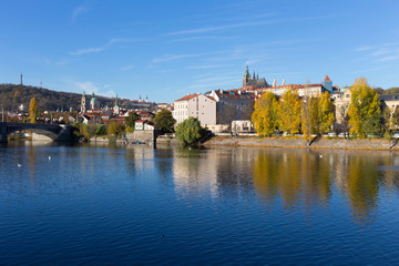 Colorful autumn Prague gothic Castle with the Lesser Town above River Vltava in the sunny Day, Czech Republic
