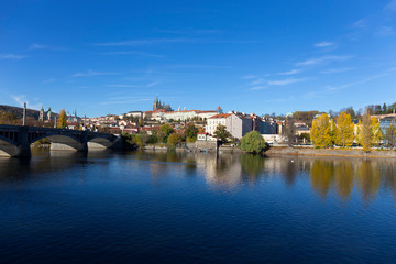Colorful autumn Prague gothic Castle with the Lesser Town above River Vltava in the sunny Day, Czech Republic