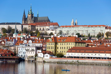 Colorful autumn Prague gothic Castle with the Lesser Town above River Vltava in the sunny Day,...