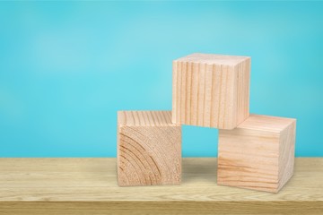 Wooden cubes on table background