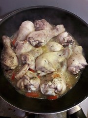 Cooking chiken legs in a pan