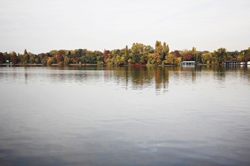 Obraz premium Colorful trees reflecting in the water. Beautiful autumn day. 