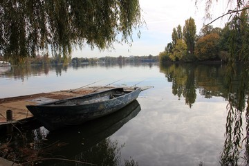 Wooden boat on the bank of lake  during fall season