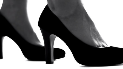 Closeup of female legs in high-heeled shoes, feminism concept, womens rights