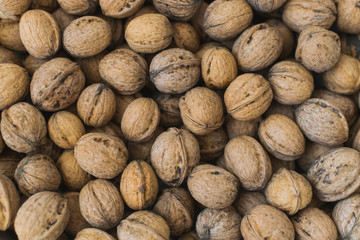 Natural walnut background pattern texture Abstract walnuts heap pattern background Blurred edges frame Natural food in-shell nuts walnuts pattern backdrop Walnuts in shell background dramatic contrast