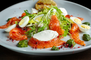 Salad from eggs, greens and trout.