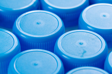 Close up of blue drinks bottle tops