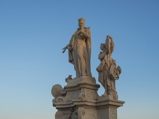 Fototapeta na wymiar Baroque sand stone Statue Saint on Charles Bridge in Prague, Czech Republic, sunny day, clear blue sky